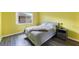 Bedroom featuring a bed, side table, lamp, and a view from the window at 116 Vista Hermosa Cir # 204C, Sarasota, FL 34242