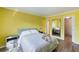 Bright bedroom features a comfortable bed, side tables, and a full-length mirror at 116 Vista Hermosa Cir # 204C, Sarasota, FL 34242