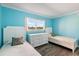 Bright, airy bedroom with two twin beds, a white dresser, and a window overlooking the landscape at 116 Vista Hermosa Cir # 204C, Sarasota, FL 34242