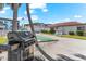 Outdoor grill and seating area with shuffleboard court at 116 Vista Hermosa Cir # 204C, Sarasota, FL 34242