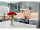Modern kitchen with a center island, quartz countertops, stainless steel appliances, and gray cabinetry at 116 Vista Hermosa Cir # 204C, Sarasota, FL 34242