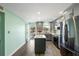 Lovely updated kitchen with stainless appliances, gray cabinets, island, and modern flooring at 116 Vista Hermosa Cir # 204C, Sarasota, FL 34242