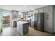 Bright, updated kitchen with stainless appliances, gray cabinetry, an island, and wood-look flooring at 116 Vista Hermosa Cir # 204C, Sarasota, FL 34242