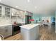 Beautiful kitchen with gray cabinets, stainless appliances, kitchen island, and modern backsplash at 116 Vista Hermosa Cir # 204C, Sarasota, FL 34242