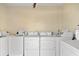 Clean, well-maintained laundry room equipped with multiple washing machines and dryers at 116 Vista Hermosa Cir # 204C, Sarasota, FL 34242