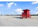 Scenic beach view featuring a bright red lifeguard stand on a pristine white sandy beach at 116 Vista Hermosa Cir # 204C, Sarasota, FL 34242