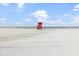 Picturesque lifeguard stand on a serene beach with clear skies and calm waters at 116 Vista Hermosa Cir # 204C, Sarasota, FL 34242
