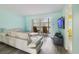 Bright and airy living room with access to a patio through sliding doors and comfortable furniture at 116 Vista Hermosa Cir # 204C, Sarasota, FL 34242