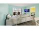 Bright living room with sleek furniture, a sliding glass door to the patio, and a wall-mounted TV at 116 Vista Hermosa Cir # 204C, Sarasota, FL 34242