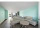 Bright open-concept living space flowing into modern kitchen; features wood floors and a sleek sectional at 116 Vista Hermosa Cir # 204C, Sarasota, FL 34242