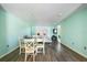 Bright, airy living room with modern furniture, gray floors and a dining table with seating for four at 116 Vista Hermosa Cir # 204C, Sarasota, FL 34242