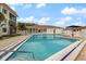 Beautiful community pool with clear blue water, showcasing ample space for swimming and lounging under sunny skies at 116 Vista Hermosa Cir # 204C, Sarasota, FL 34242