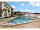 Relaxing community pool with pristine blue water surrounded by well-maintained landscaping and comfortable seating areas at 116 Vista Hermosa Cir # 204C, Sarasota, FL 34242