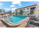 Community pool with lounge chairs and well-maintained landscaping at 116 Vista Hermosa Cir # 204C, Sarasota, FL 34242