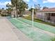 Well-maintained shuffleboard courts surrounded by lush landscaping and charming residential buildings at 116 Vista Hermosa Cir # 204C, Sarasota, FL 34242