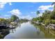 Scenic waterfront view with docks and boats under a blue sky and scattered clouds at 116 Vista Hermosa Cir # 204C, Sarasota, FL 34242