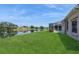 Expansive backyard featuring lush green lawn with stunning lake views, providing a serene outdoor space at 12007 Clubhouse Dr, Lakewood Ranch, FL 34202