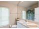 Bathroom with lots of natural light, featuring a large mirror and a white single sink vanity at 12007 Clubhouse Dr, Lakewood Ranch, FL 34202