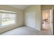 Bedroom with neutral carpet, closet, and large window letting in natural light at 12007 Clubhouse Dr, Lakewood Ranch, FL 34202