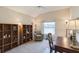 Bedroom features a vaulted ceiling, large window with pond view, and two large shelving units at 12007 Clubhouse Dr, Lakewood Ranch, FL 34202