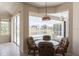 Bright dining area features a round glass table with seating for four overlooking the pool at 12007 Clubhouse Dr, Lakewood Ranch, FL 34202