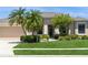 Charming single-story home with mature landscaping, palm trees, and a well-maintained lawn at 12007 Clubhouse Dr, Lakewood Ranch, FL 34202