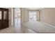 Open living space with tile flooring, leading to an outdoor patio with lake views at 12007 Clubhouse Dr, Lakewood Ranch, FL 34202
