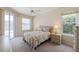 The main bedroom is bright and features a ceiling fan, two windows and sliding glass doors at 12007 Clubhouse Dr, Lakewood Ranch, FL 34202