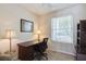 Home office features a desk, shelving, and a window providing natural light at 12007 Clubhouse Dr, Lakewood Ranch, FL 34202