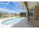 Relaxing screened-in pool with covered seating and a lovely view of the lake at 12007 Clubhouse Dr, Lakewood Ranch, FL 34202