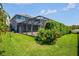 Well maintained backyard featuring a vibrant garden and blue house with screened in patio at 12214 Streambed Dr, Riverview, FL 33579