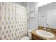 Bathroom featuring a shower with pineapple print curtain, single vanity, and floating shelves at 12214 Streambed Dr, Riverview, FL 33579