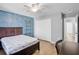 Bedroom features hardwood flooring, brick accent wall, closet, and desk space at 12214 Streambed Dr, Riverview, FL 33579