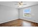 Bedroom with wood floors, ceiling fan, and a window with natural light at 12214 Streambed Dr, Riverview, FL 33579