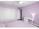 Bedroom with wood floors, lavender walls, and white furniture at 12214 Streambed Dr, Riverview, FL 33579