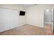 Bedroom boasts carpet flooring, closet, and a mounted television for entertainment at 12214 Streambed Dr, Riverview, FL 33579