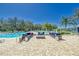 Community pool area featuring outdoor lounge areas, pool, and trees at 12214 Streambed Dr, Riverview, FL 33579