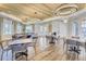 The community room offers tables, chairs, chandeliers, and hardwood floors for a comfortable gathering space at 12214 Streambed Dr, Riverview, FL 33579