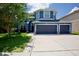 Charming two-story blue home with a three car garage and well maintained landscaping at 12214 Streambed Dr, Riverview, FL 33579