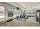 The gym features modern equipment, large windows, and mirrored walls for fitness enthusiasts at 12214 Streambed Dr, Riverview, FL 33579