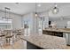 Eat-in kitchen featuring granite countertops, stainless steel appliances, and backyard access at 12214 Streambed Dr, Riverview, FL 33579