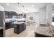 Well-lit kitchen featuring dark cabinets, stainless steel appliances, and granite countertops at 12214 Streambed Dr, Riverview, FL 33579