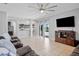 Bright and spacious living room with tile floors and open access to the kitchen and pool at 12214 Streambed Dr, Riverview, FL 33579