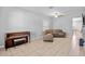 Cozy living room with a piano, leather furniture, and tile flooring at 12214 Streambed Dr, Riverview, FL 33579