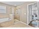 Main bathroom featuring a garden tub, tiled shower, and neutral walls at 12214 Streambed Dr, Riverview, FL 33579
