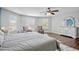 Bright main bedroom with wood floors, sitting area, and natural light at 12214 Streambed Dr, Riverview, FL 33579