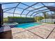 Inviting screened-in pool and spa featuring brick pavers and manicured hedges at 12214 Streambed Dr, Riverview, FL 33579