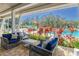 This poolside patio includes comfortable seating and lush landscaping in a vibrant setting at 12214 Streambed Dr, Riverview, FL 33579