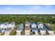 Aerial view of homes surrounded by trees and landscape at 12520 Shimmering Oak Cir, Venice, FL 34293