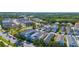 An aerial view captures a neighborhood's layout, showcasing well-maintained homes, landscaping, and nearby park areas at 12520 Shimmering Oak Cir, Venice, FL 34293